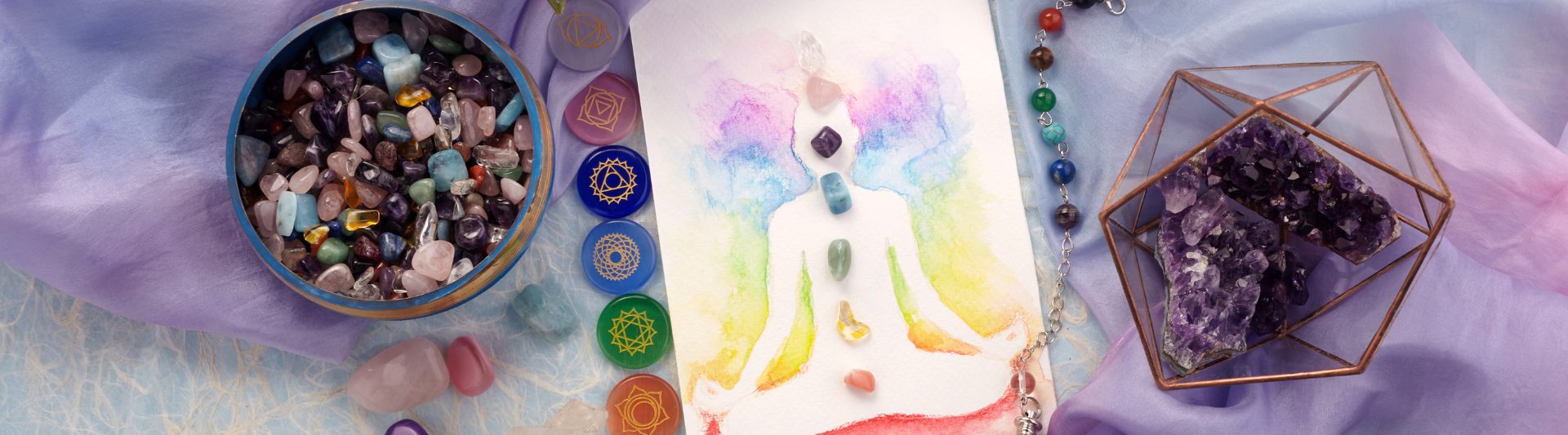 Image of a yoga pose drawing with 7 chakras and corresponding gemstones